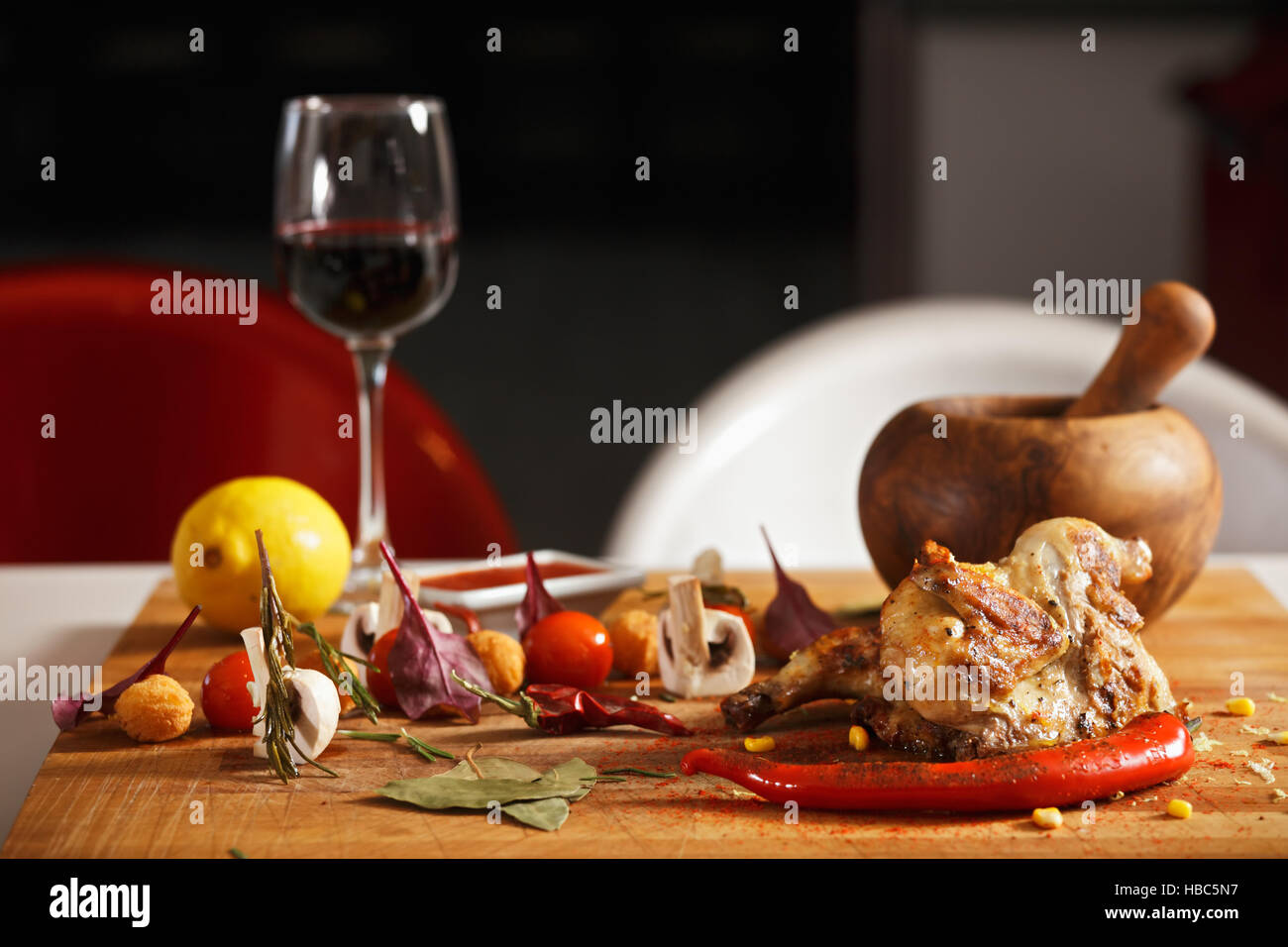 Roasted chicken with vegetables on table Stock Photo