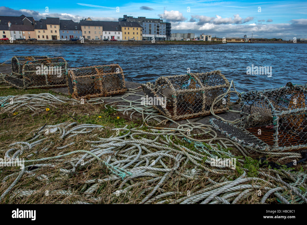 Fishing nets and lobster cages on Claddagh in Galway. Colorful houses