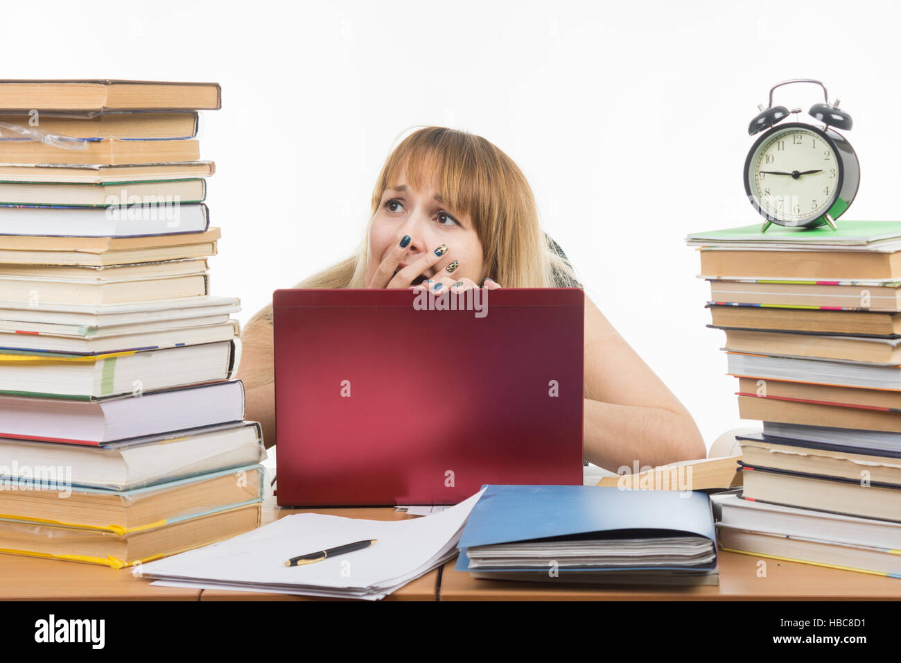 Student shocked looking at books Stock Photo