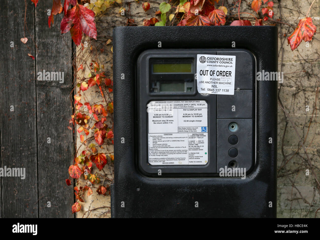Broad Street, Oxford, United Kingdom, December 04, 2016: Oxford parking meter with Out of order notice sticker and additional hand written notice on Broad Street, Oxford. Stock Photo