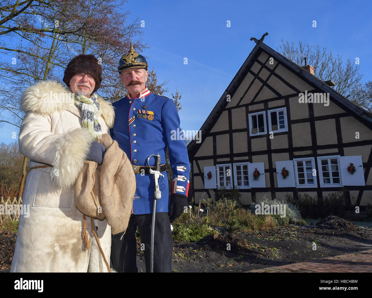 Lehde, Germany. 3rd Dec, 2016. Rumpodich (l), the Knecht Ruprecht (approx. Santa's little helper) of the Spreewald region, and Gendarm von Boblitz in conversation at the Christmas Market at the Freilandmuseum in the Spreewald village of Lehde, Germany, 3 December 2016. Visitors can visit the Christmas Market by barge and learn about the customs and traditions of the Spreewald's inhabitants. Photo: Patrick Pleul/dpa-Zentralbild/ZB/dpa/Alamy Live News Stock Photo