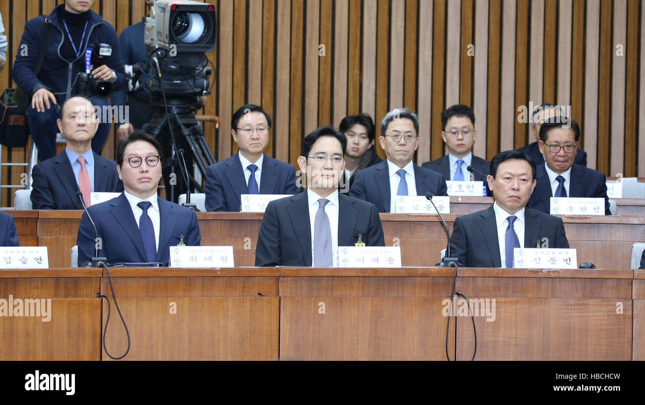 (161206) -- SEOUL, Dec. 6, 2016 (Xinhua) -- SK Group chairman Chey Tae-Won, Samsung Electronics Vice Chairman Lee Jae-yong and Lotte Group Chairman Shin Dong-Bin (front, L to R) attend the first parliamentary hearing for a scandal involving President Park Geun-hye in Seoul, South Korea, Dec. 6, 2016. Chiefs of South Korea's major conglomerates on Tuesday attended the first parliamentary hearing for a scandal involving President Park Geun-hye, being reminiscent of the 1988 interrogation of chaebol heads over the country's deep-rooted collusive links between politicians and businessmen. (Xinhua/ Stock Photo
