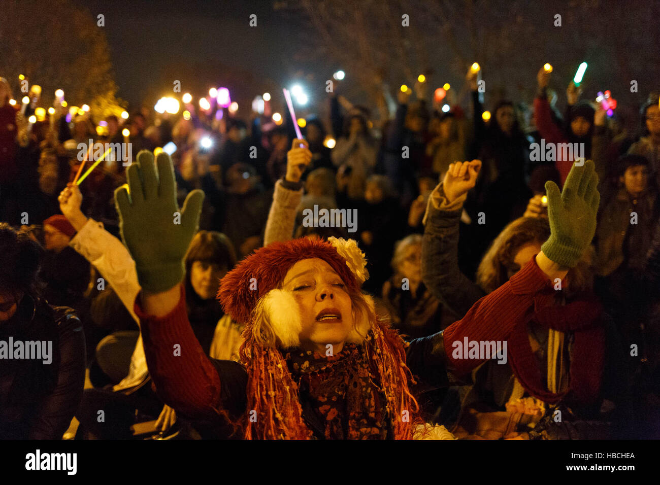 Oakland, USA. 05th Dec, 2016. People raise candles during a moment of silence at a vigil for victims of the Ghost Ship warehouse fire. Credit:  John Orvis/Alamy Live News Stock Photo
