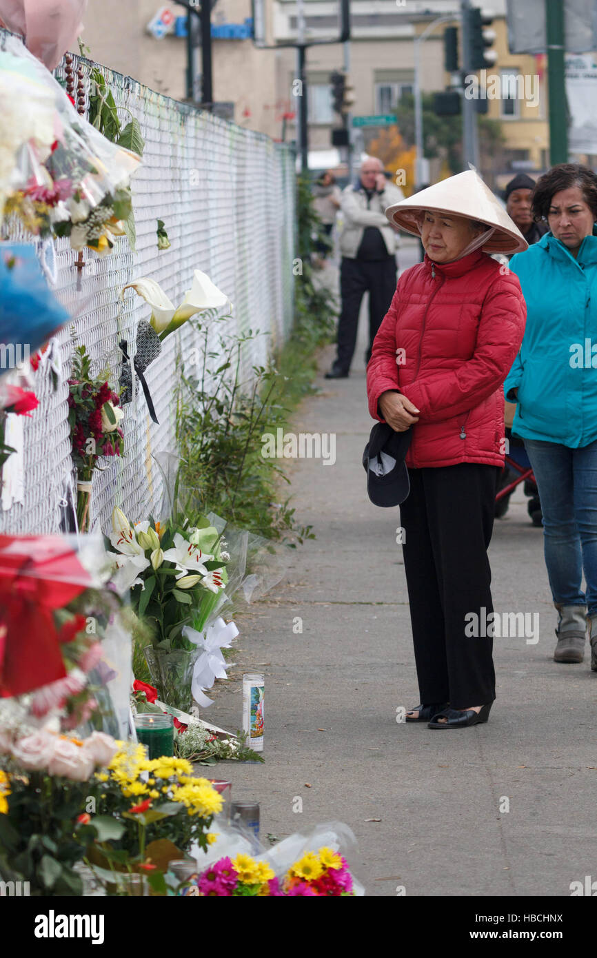 Oakland, USA. 05th Dec, 2016. A woman stands at a makeshift memorial outside the Ghost Ship warehouse, which burned last Friday. 33 people have been recovered from the rubble so far. Credit:  John Orvis/Alamy Live News Stock Photo