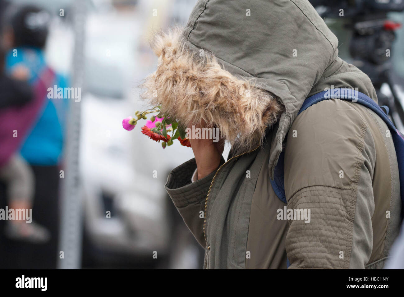 Oakland, USA. 05th Dec, 2016. A woman cries at the makeshift memorial outside the Ghost Ship warehouse. Credit:  John Orvis/Alamy Live News Stock Photo