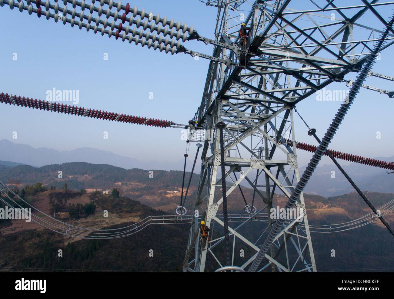 Chongqing. 6th Dec, 2016. Technicians inspect the tower of the ¡À800KV Ultra High Voltage (UHV) transmission line in Wushan County of southwest China's Chongqing, Dec. 6, 2016. The ¡À800KV UHV transmission line will run 2,383 meters from Jiuquan in northwest China's Gansu Province to Xiangtan in central China's Hunan Province. It's so far the longest transmission line of its kind in China. © Liu Chan/Xinhua/Alamy Live News Stock Photo