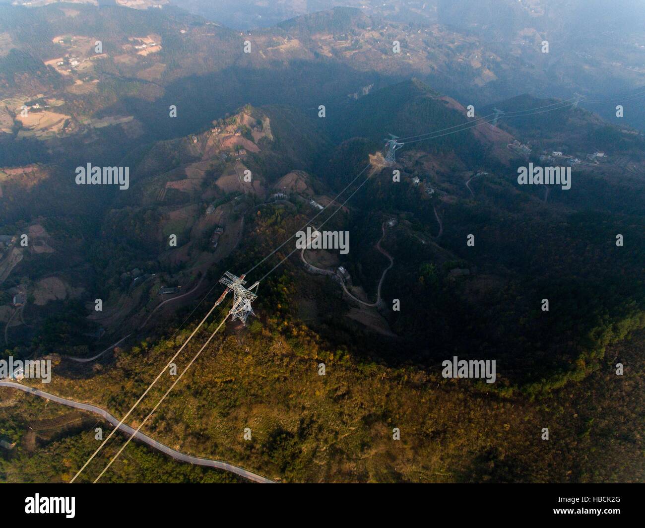 Chongqing. 6th Dec, 2016. Photo taken on Dec. 6, 2016 shows the ¡À800KV Ultra High Voltage (UHV) transmission line in Wushan County of southwest China's Chongqing. The ¡À800KV UHV transmission line will run 2,383 meters from Jiuquan in northwest China's Gansu Province to Xiangtan in central China's Hunan Province. It's so far the longest transmission line of its kind in China. © Liu Chan/Xinhua/Alamy Live News Stock Photo