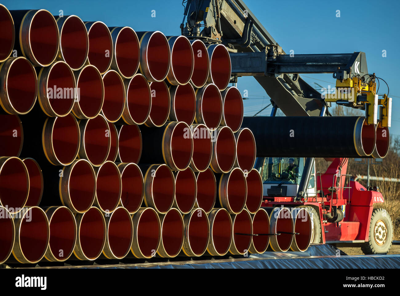 A special crane stacks pipes weighing several tons each which will be ...