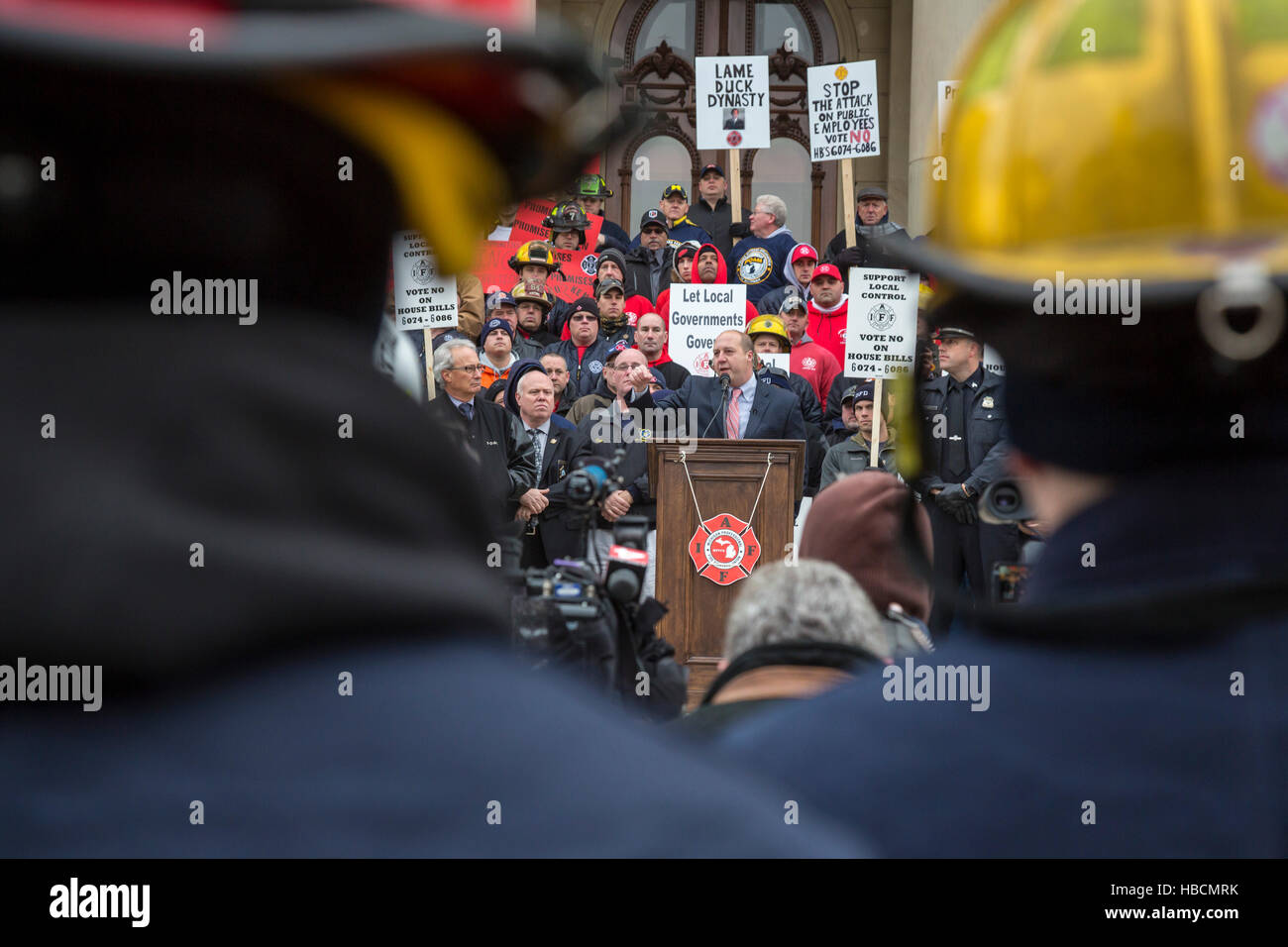 Michigan, USA. 6th December, 2016. Firefighters and police officers rally at the Michigan state capitol to protest bills in Michigan's Republican-controlled lame duck legislature that would scale back health benefits for active and retired employees. During the rally, union leaders announced that legislative leaders had agreed to shelve the bills until the 2017 legislative session. Credit:  Jim West/Alamy Live News Stock Photo