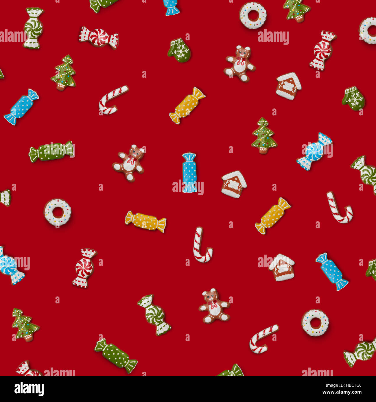 Christmas gingerbread cookies of different shapes on a red background ...