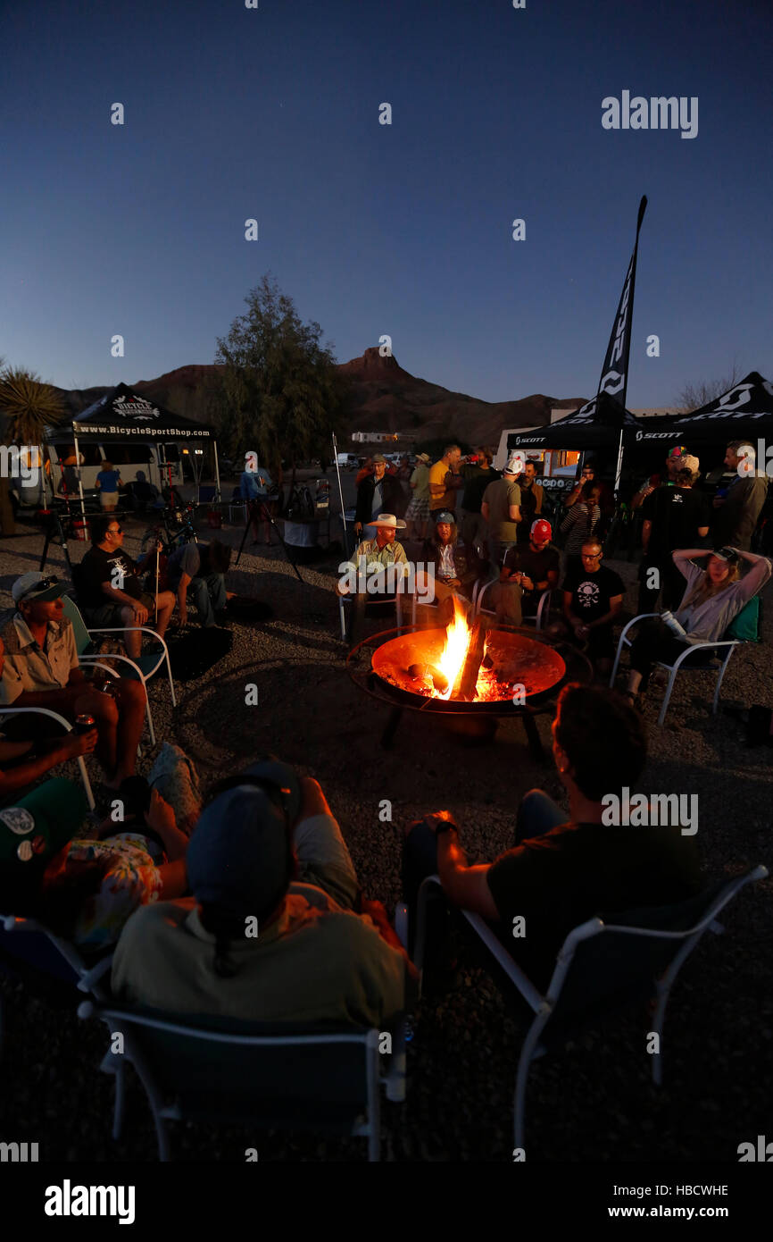 Mountain bikers sit around the fire at the Big Chihuahua Desert Challenge in Lajitas, Texas. Stock Photo