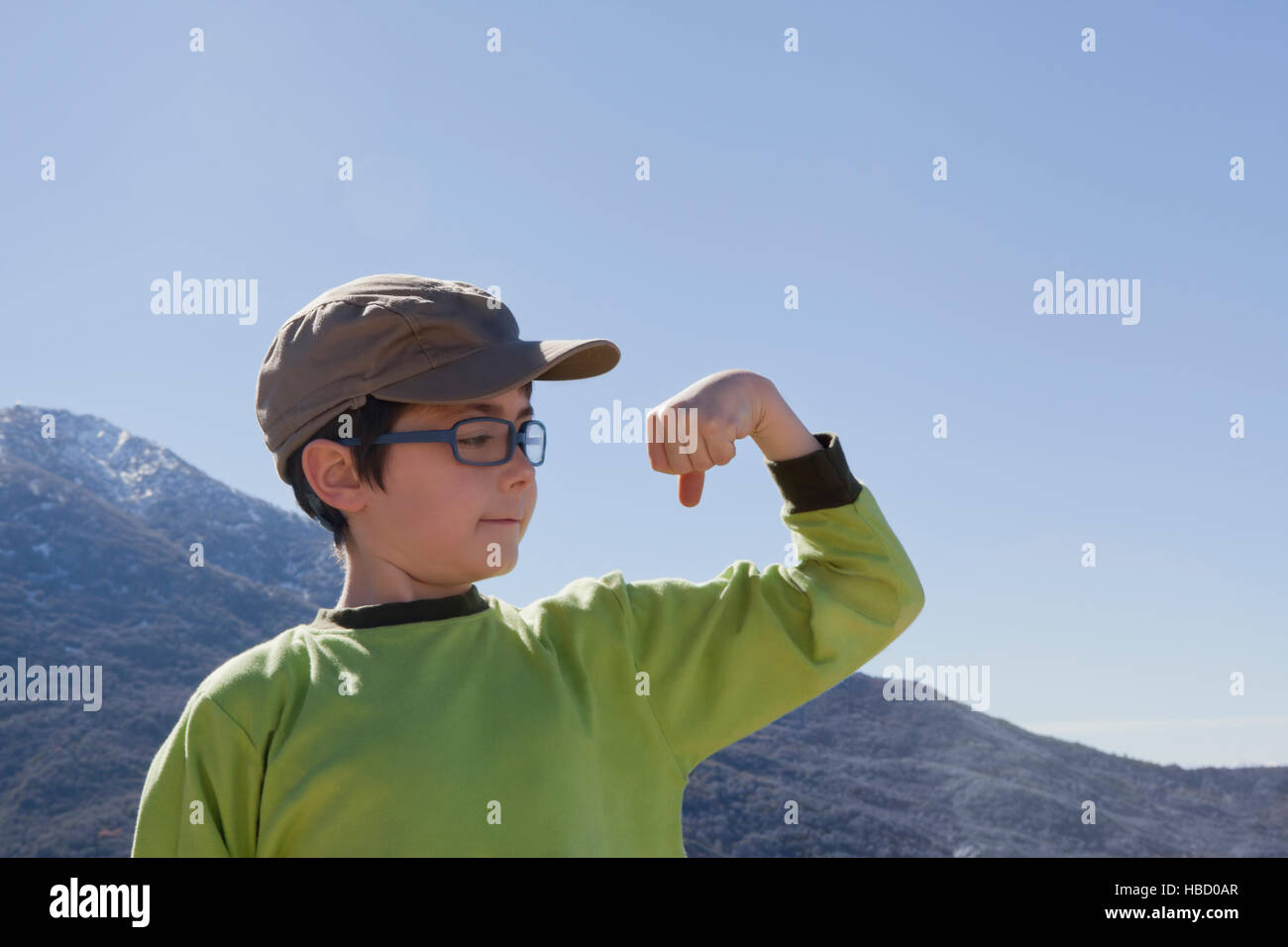 Portrait of boy flexing his muscles in Andes, Valparaiso, Chile Stock Photo