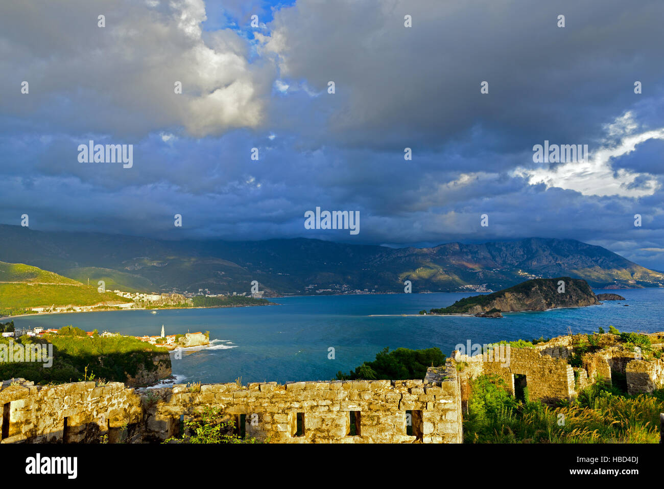 View to Budva Old town and bay from ruins of medieval fortress Tvrdava Mogren at the shore of Adriatic sea. Historic attractions of Budva, Montenegro Stock Photo