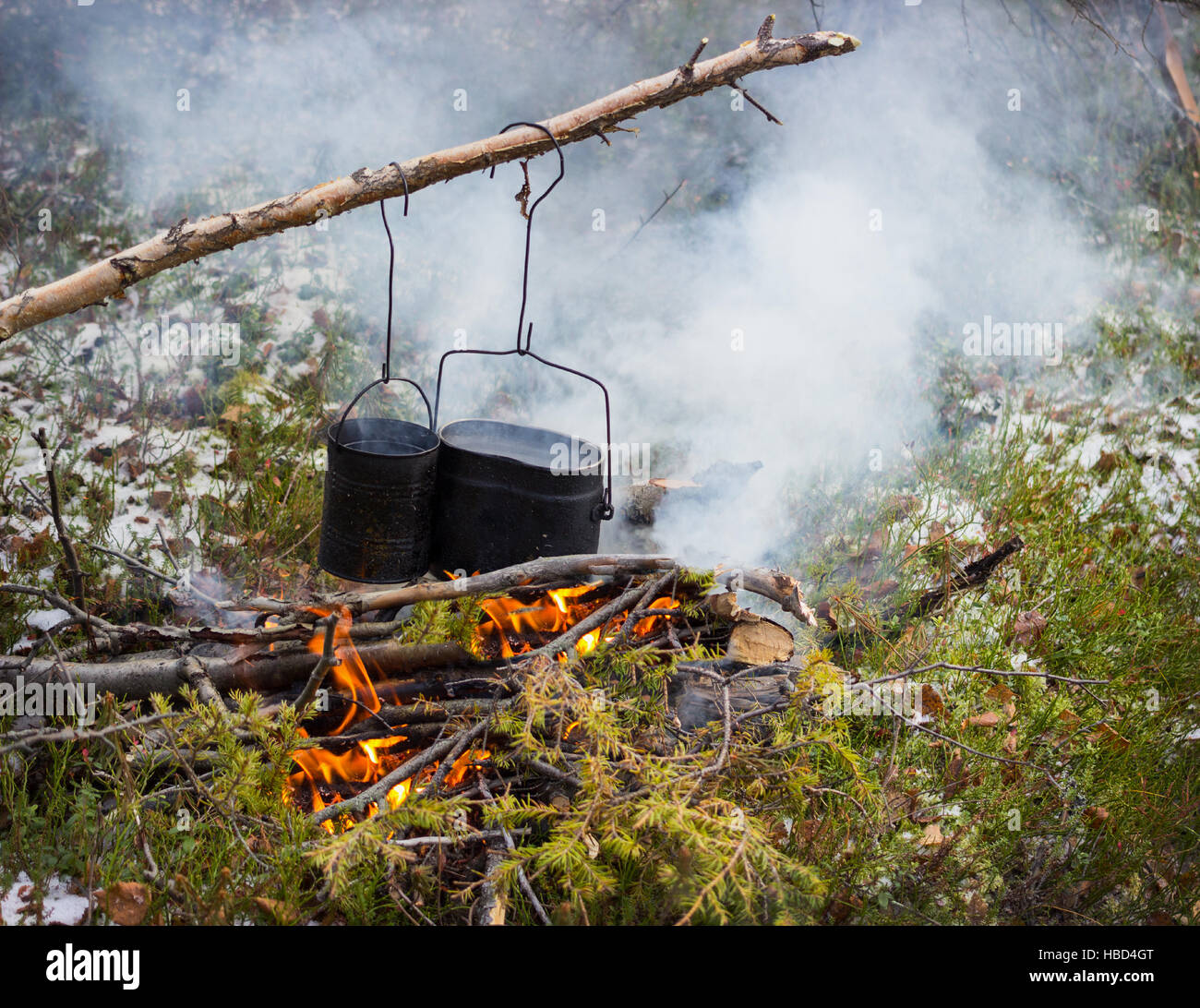 Cooking on a fire in field conditions Stock Photo
