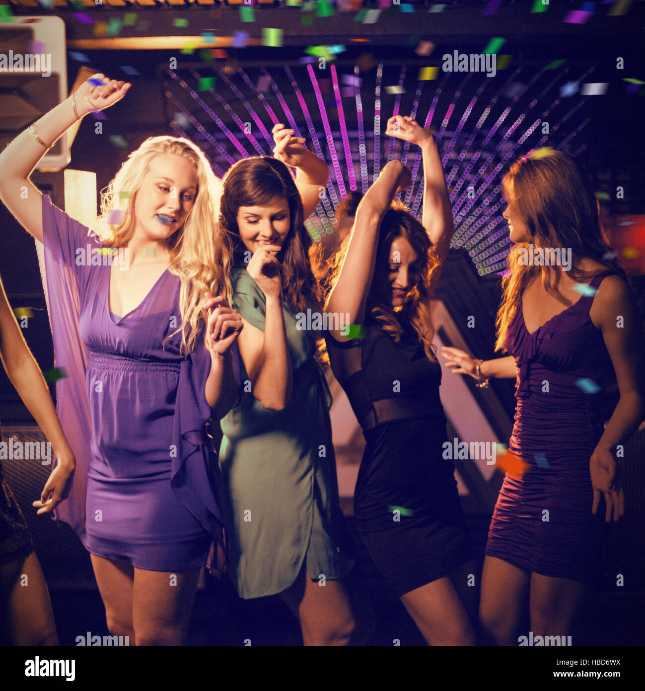 Composite image of group of smiling friends dancing on dance floor Stock Photo