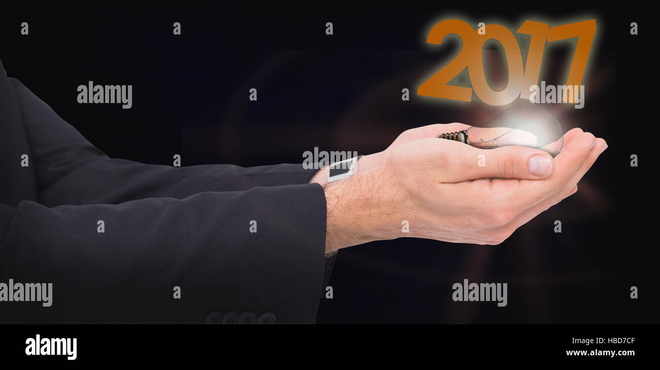 Composite image of businessman with arms out presenting something Stock Photo