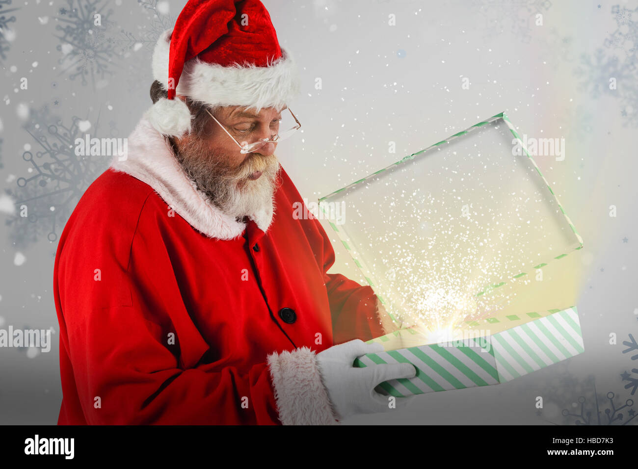 Composite image of santa claus looking at open gift box Stock Photo