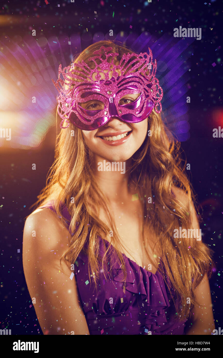 Composite image of woman wearing masquerade in bar Stock Photo