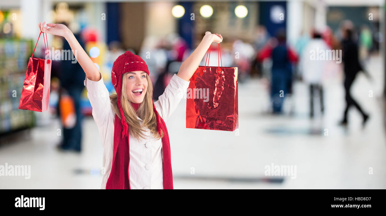Composite image of pretty blonde carrying shopping bags Stock Photo
