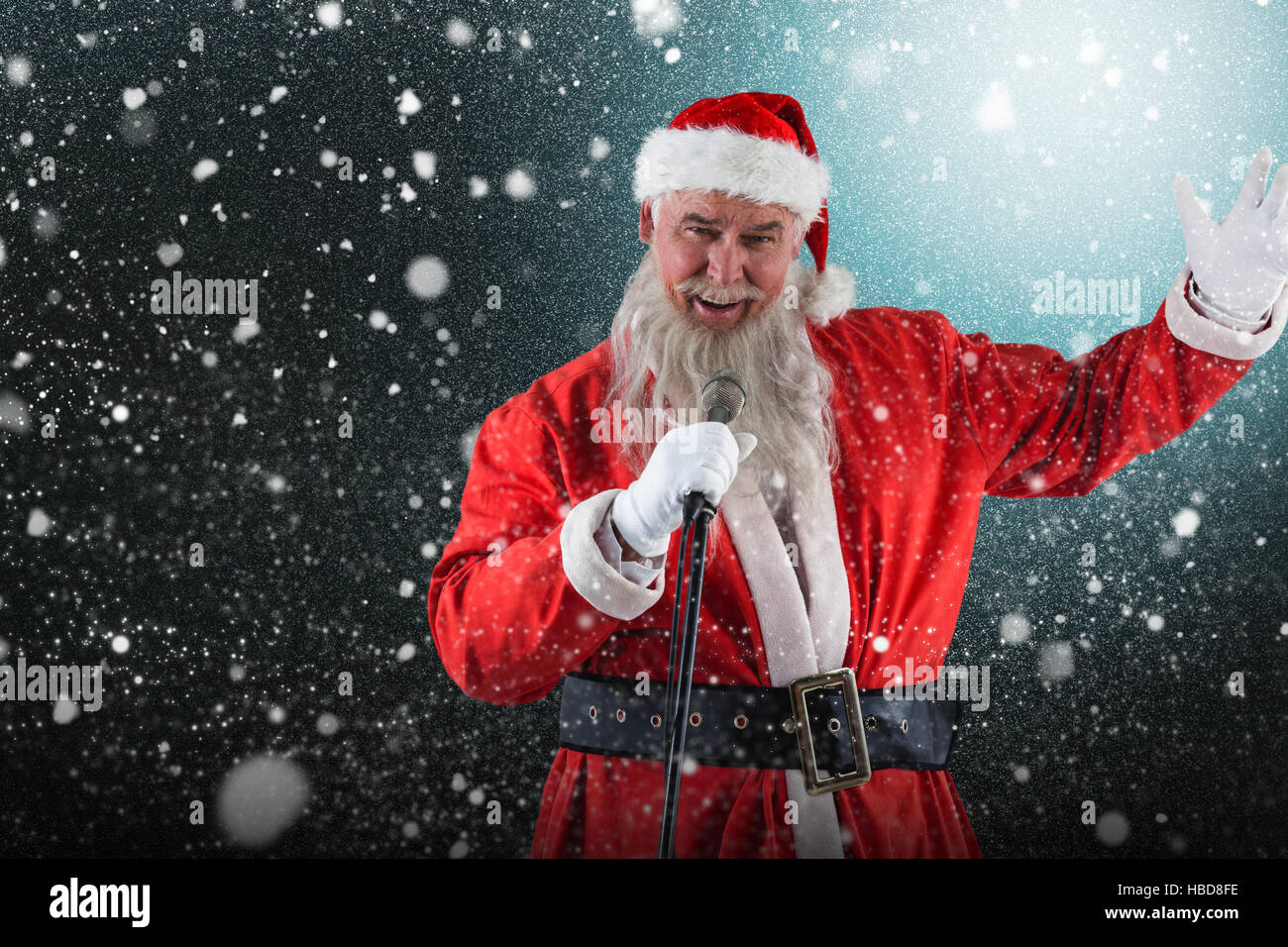 Composite image of portrait of santa claus singing christmas songs Stock Photo