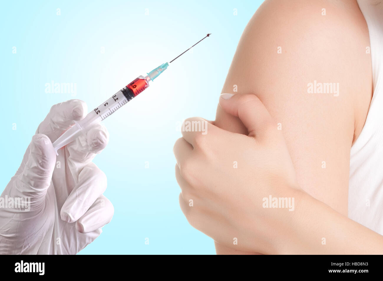 Hand holding a syringe Stock Photo