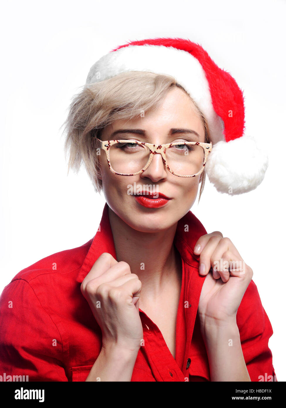 A attractive woman is wearing a Christmas cap and glasses. Stock Photo