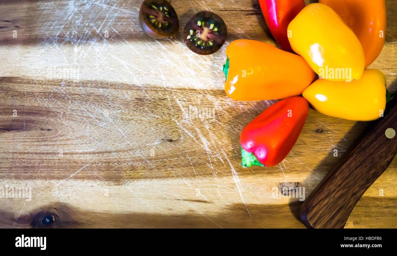 mixed paprika and knife on a cutting board Stock Photo