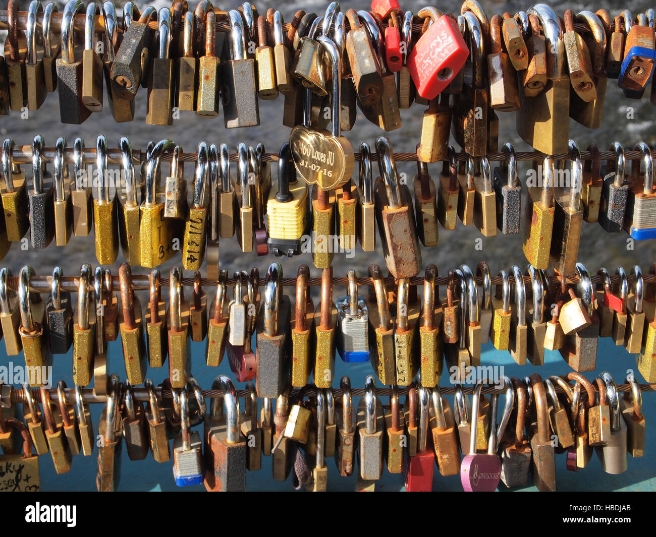 Locks on bridge that people have attached to show love for another, usually engraved or written on. They can break bridges! Stock Photo