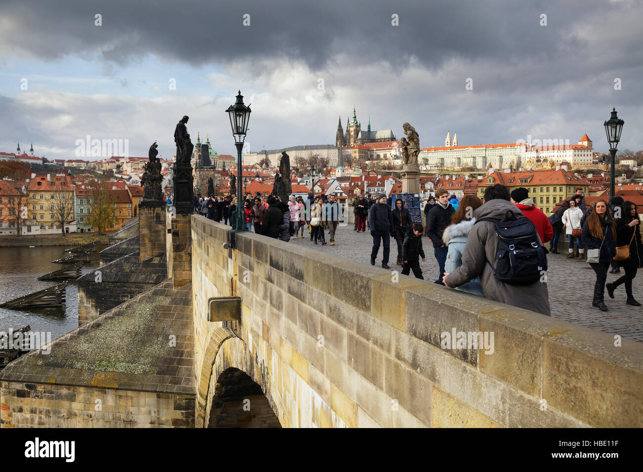 tourists walk on the Charles Bridge under a stormy sky, Prague, Czech Republic Stock Photo