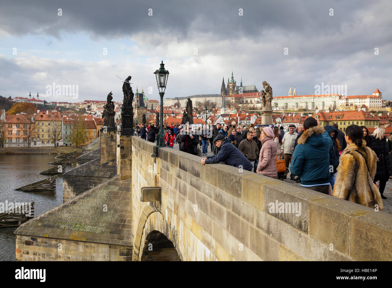 tourists walk on the Charles Bridge under a stormy sky, Prague, Czech Republic Stock Photo