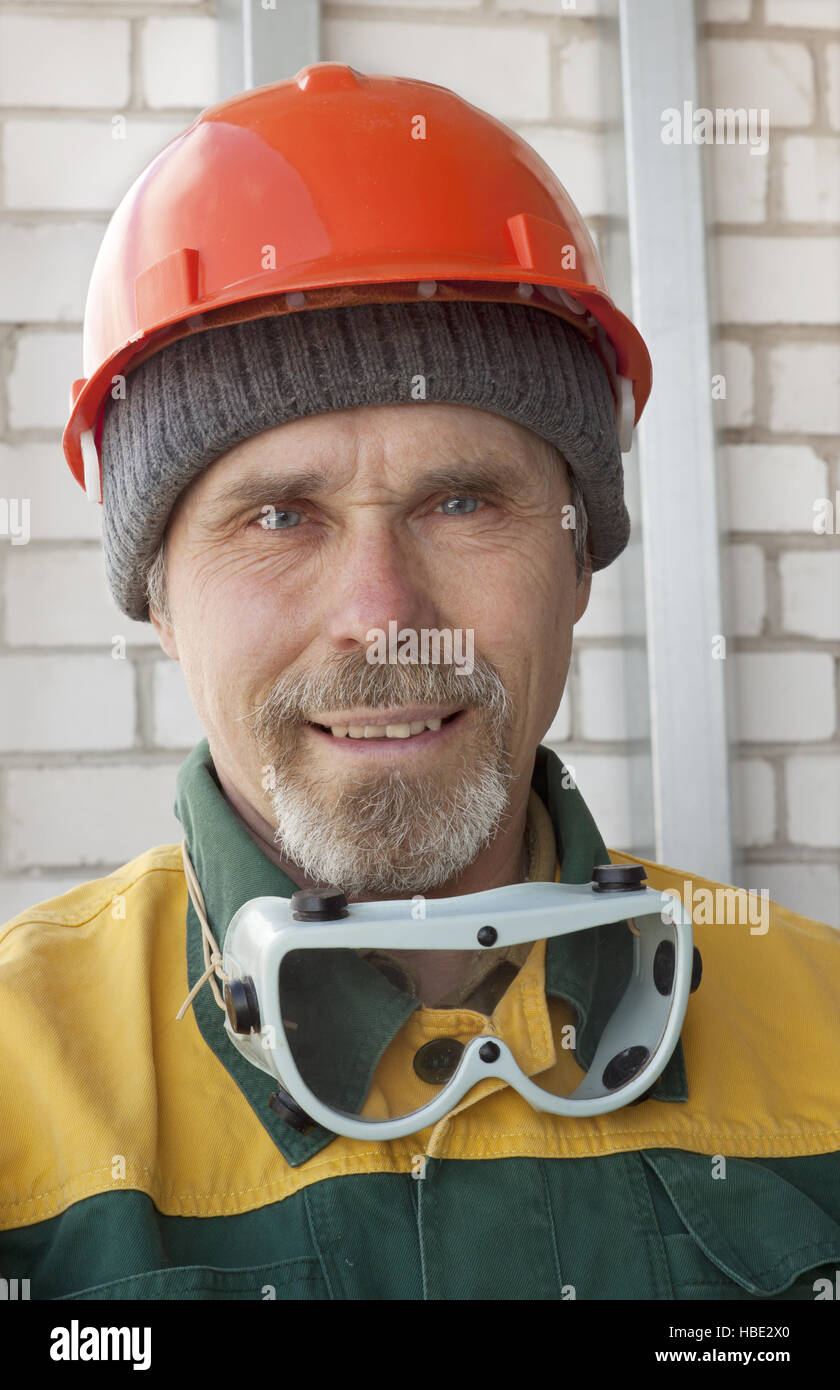 An elderly worker in protective helmet Stock Photo Alamy