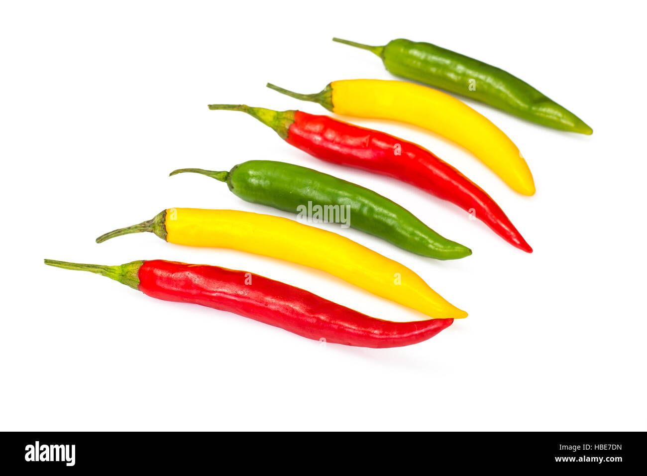Colorful chili peppers on a white background Stock Photo - Alamy