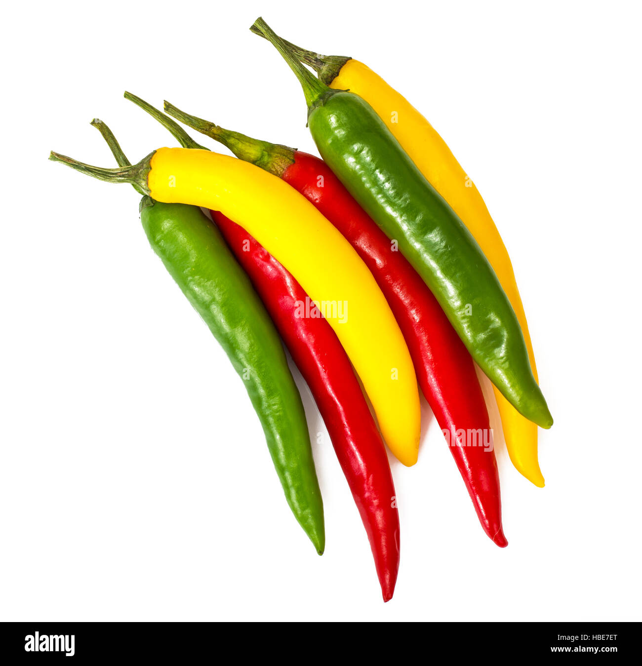 Colorful chili peppers on a white background Stock Photo - Alamy