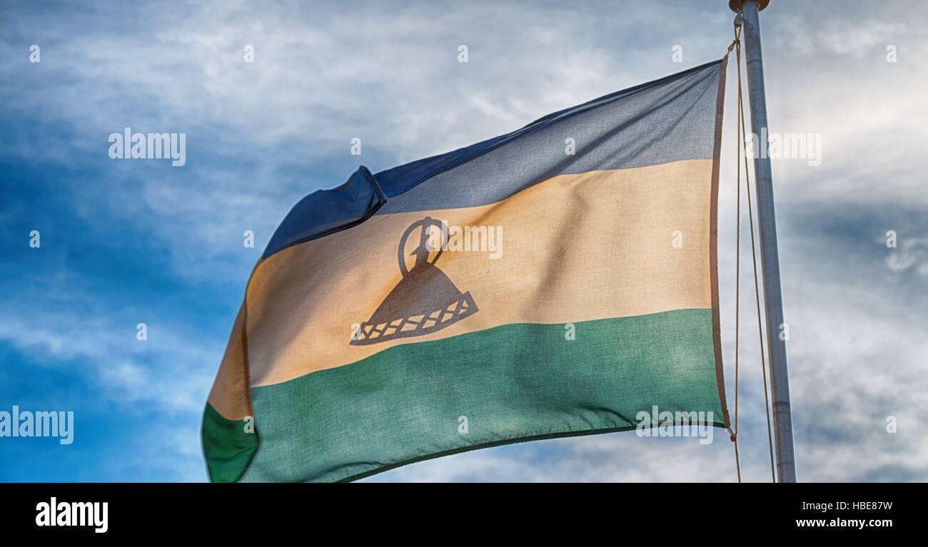 blur in lesotho waving national flag in the cloudy sky Stock Photo - Alamy