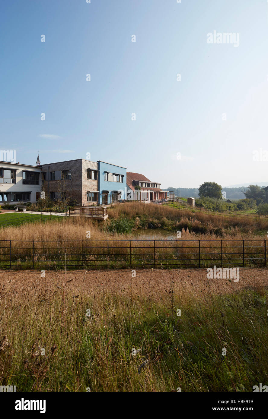 View across meadow and garden. St Michael's Hospice, Hereford, United Kingdom. Architect: Architype Limited, 2016. Stock Photo