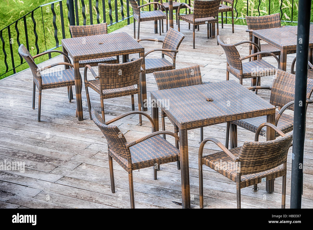 The wood table on natural outdoor of a restaurant with tree and cloudy