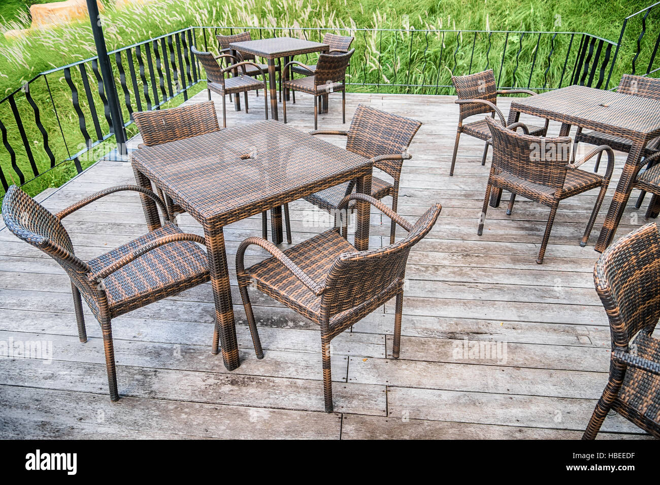 The wood table on natural outdoor of a restaurant with tree and cloudy