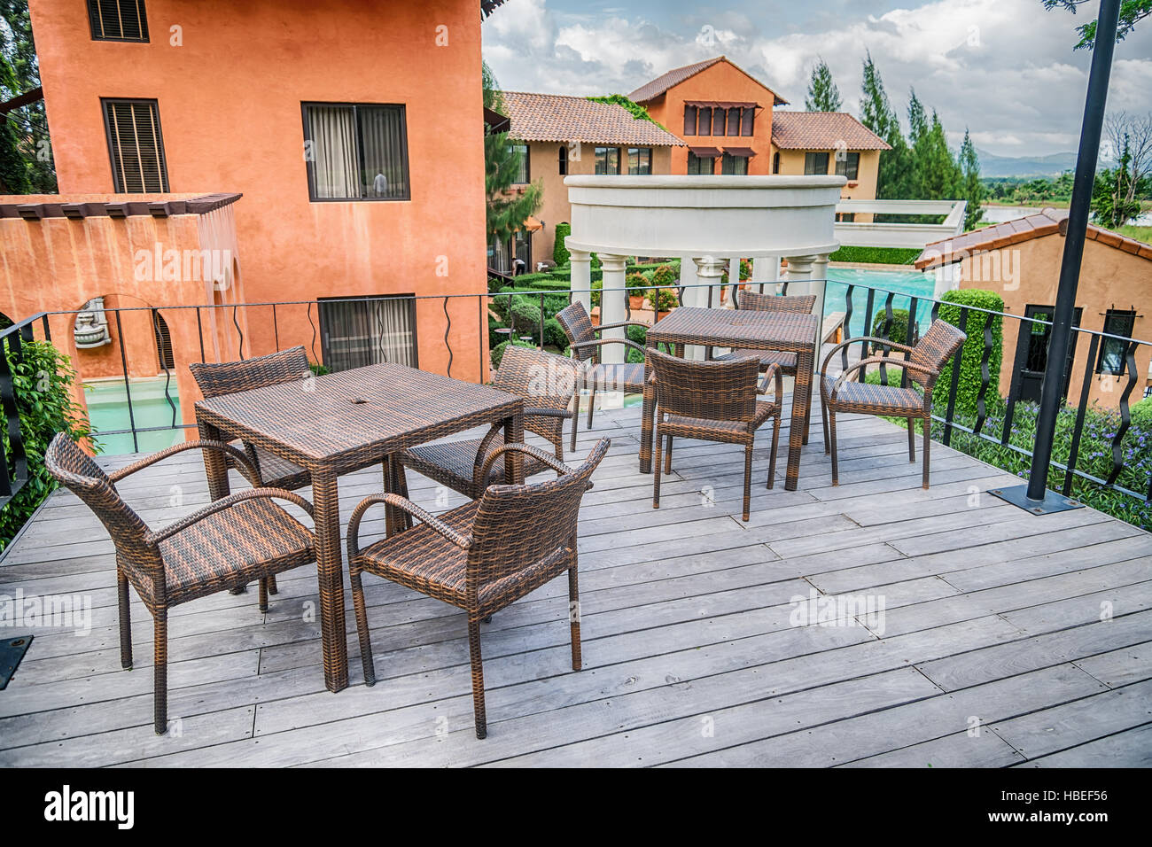The wood table on natural outdoor of a restaurant with tree and cloudy
