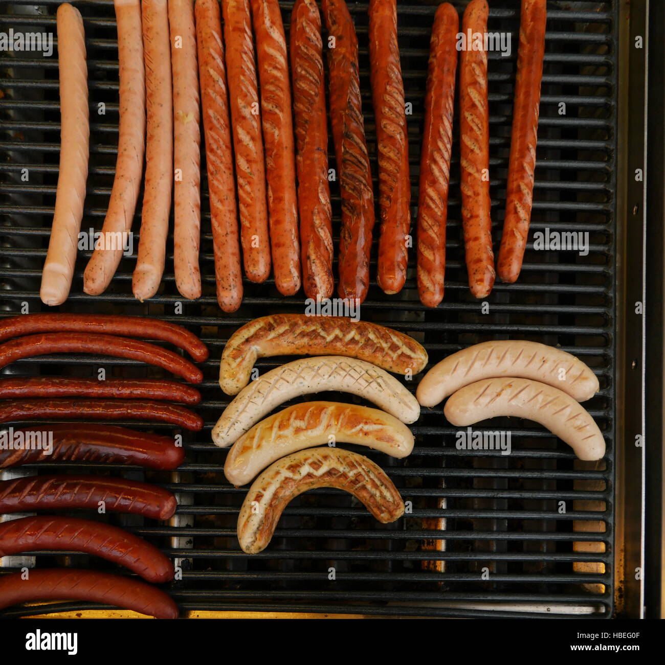 Grilling sausages on barbecue grill. Stock Photo