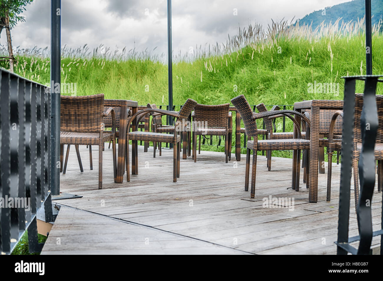 The wood table on natural outdoor of a restaurant with tree and cloudy