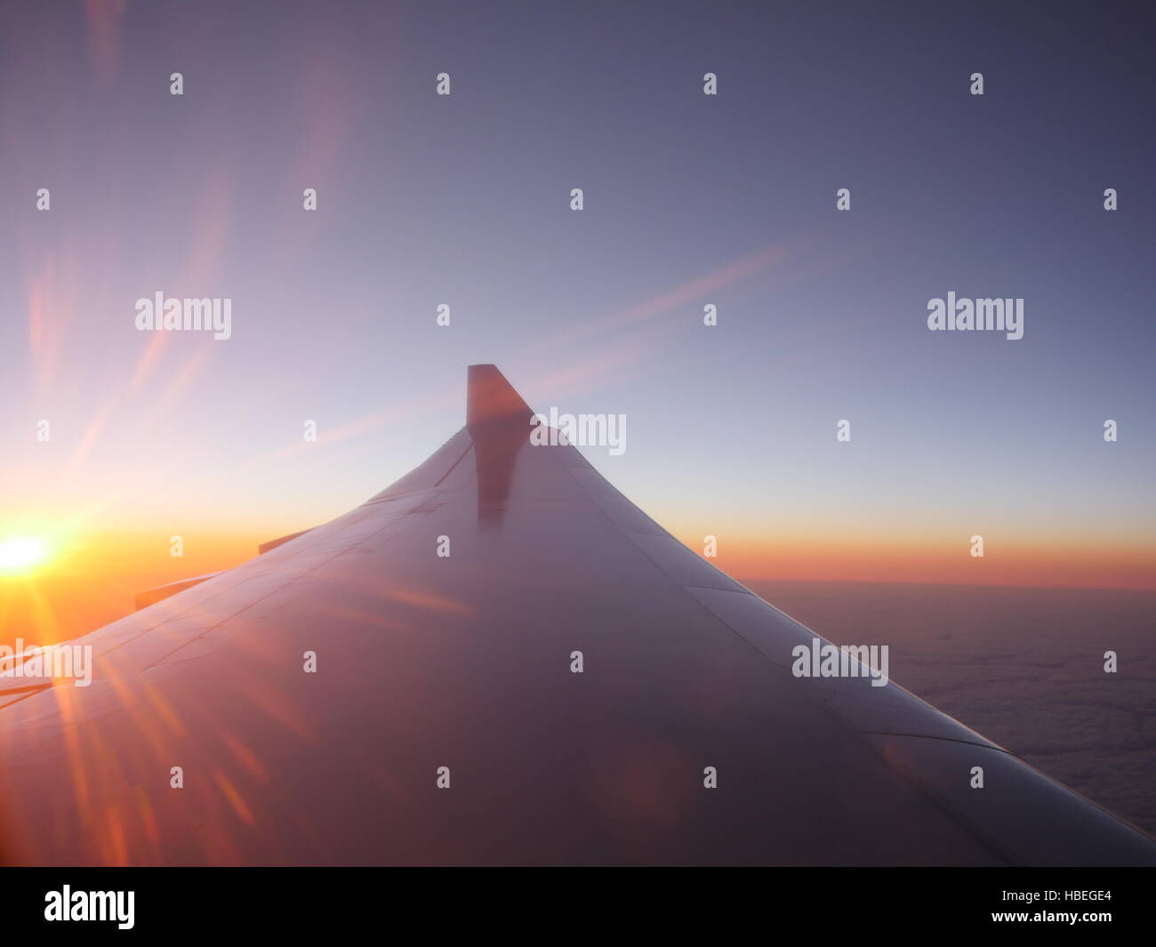 Airplane wing at sunset Stock Photo