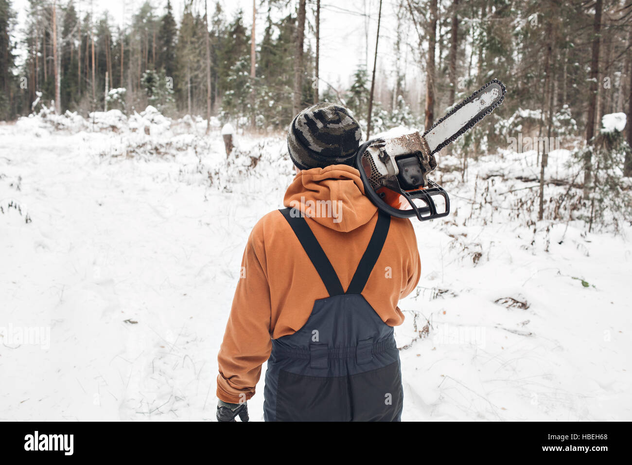 Proffesional Lumberjack hold hand saw. Winter wearing protection