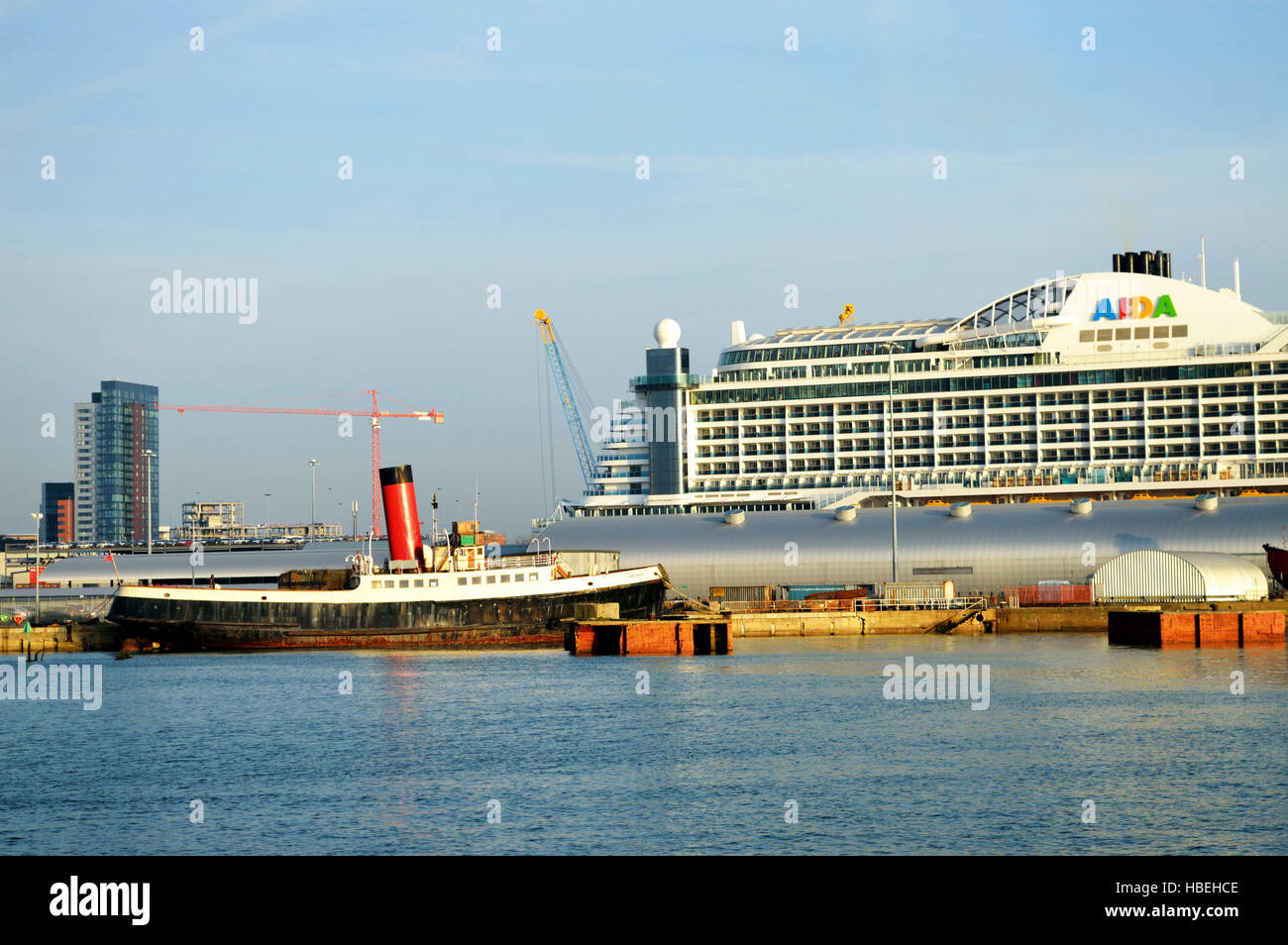 Cruise liner AIDA Prima and tug boat tender at at Ocean Cruise Terminal (Berth 46) in Southampton, UK Stock Photo