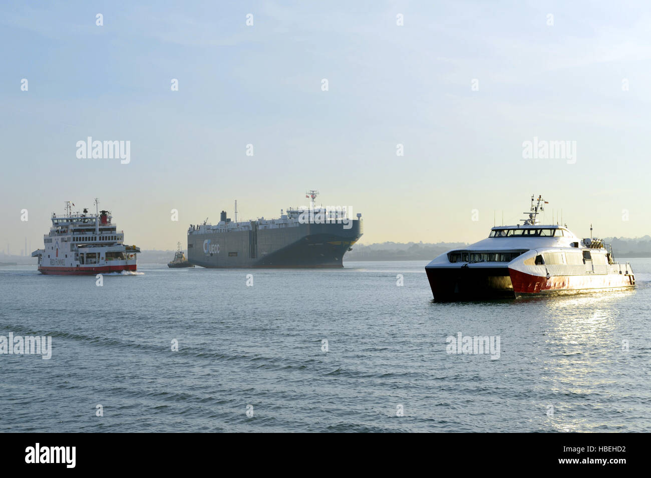 Red Osprey Ferry, cargo ship and Red Jet Ferry arriving at Southampton Water, Southampton, UK Stock Photo