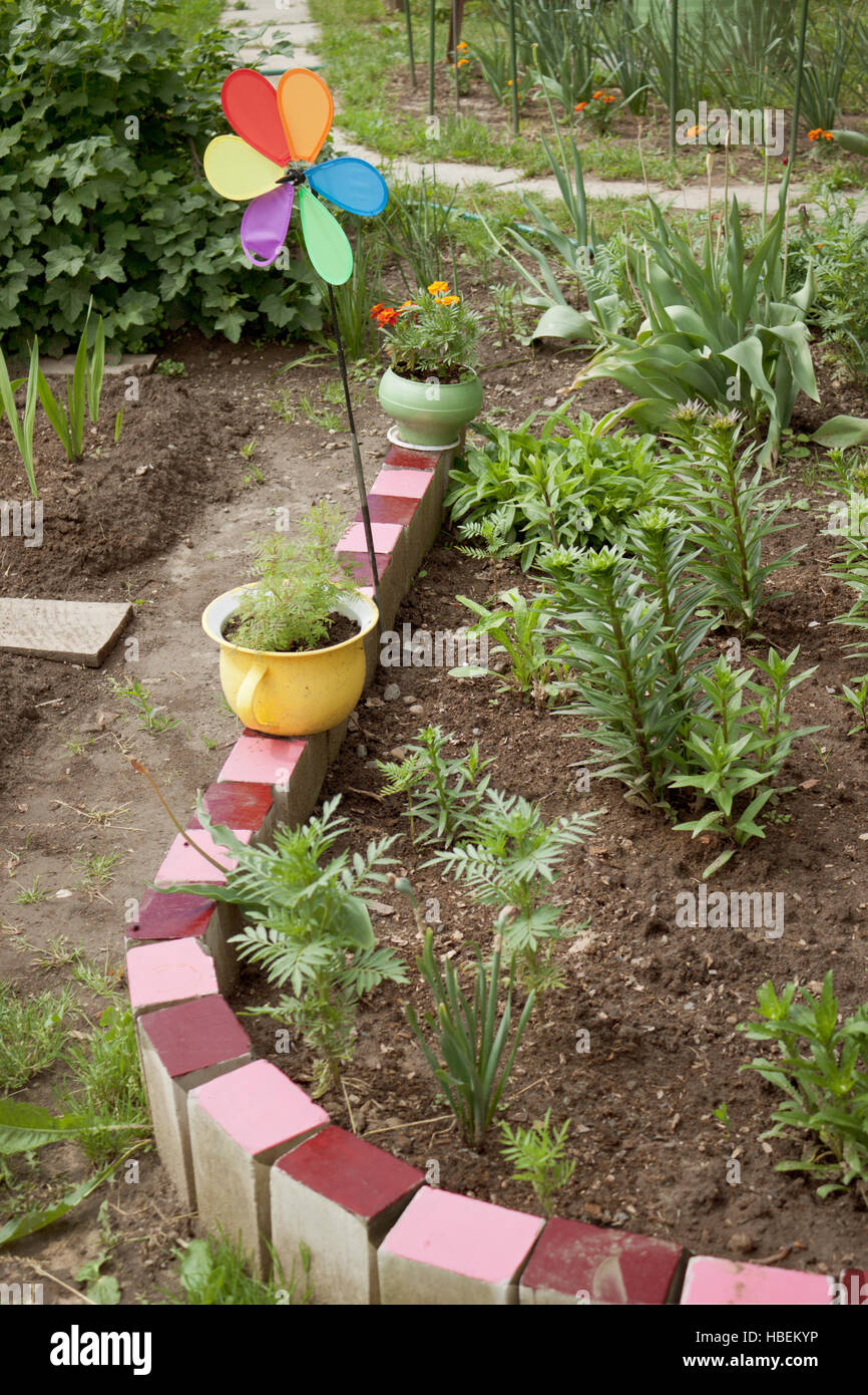 Various old objects decorate the garden Stock Photo Alamy