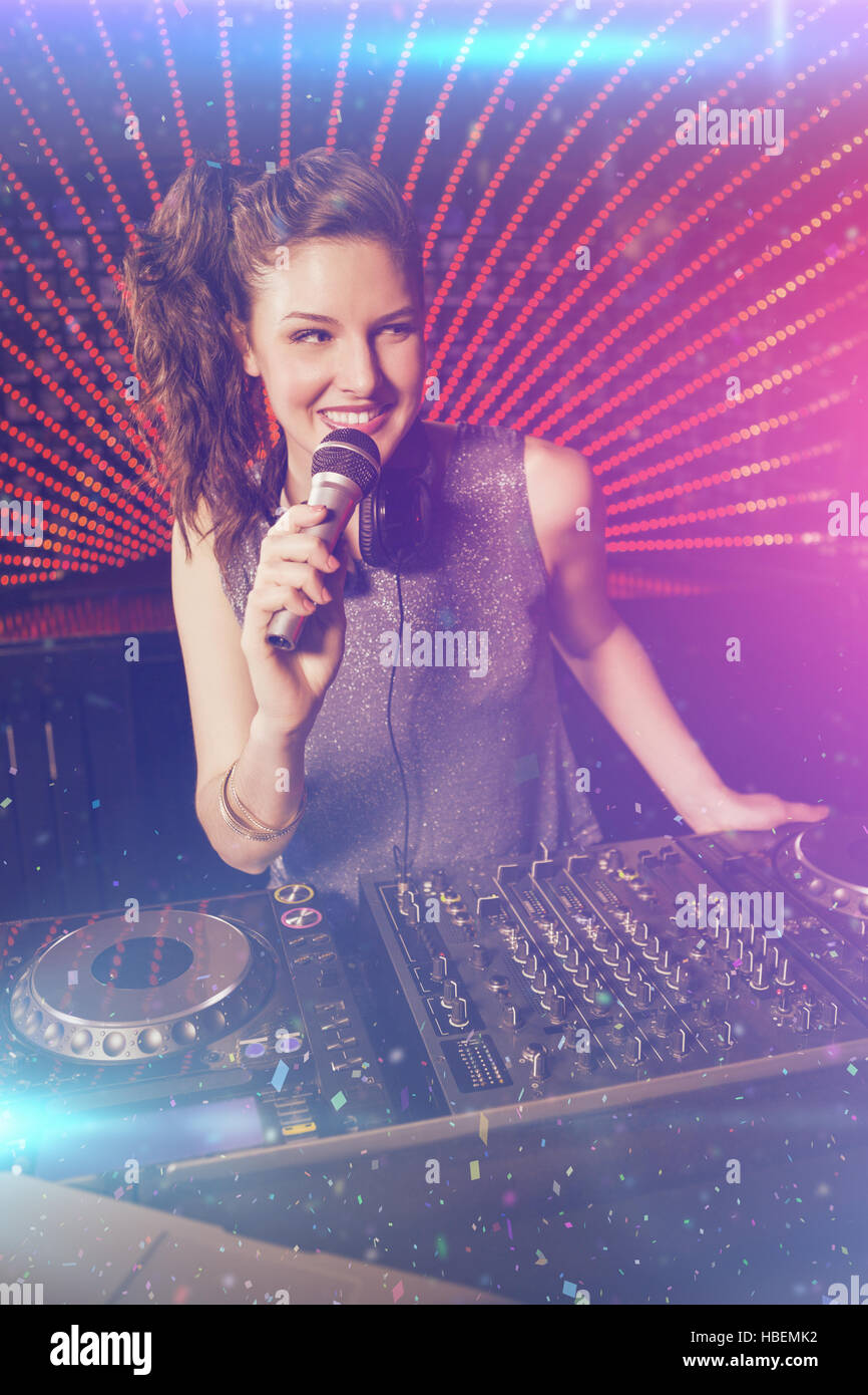 Composite image of pretty female dj playing music Stock Photo