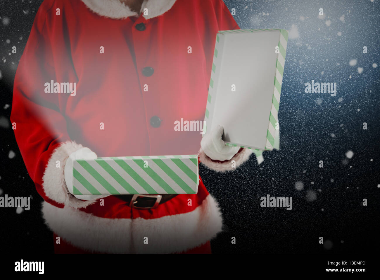 Composite image of midsection of santa claus opening gift box Stock Photo