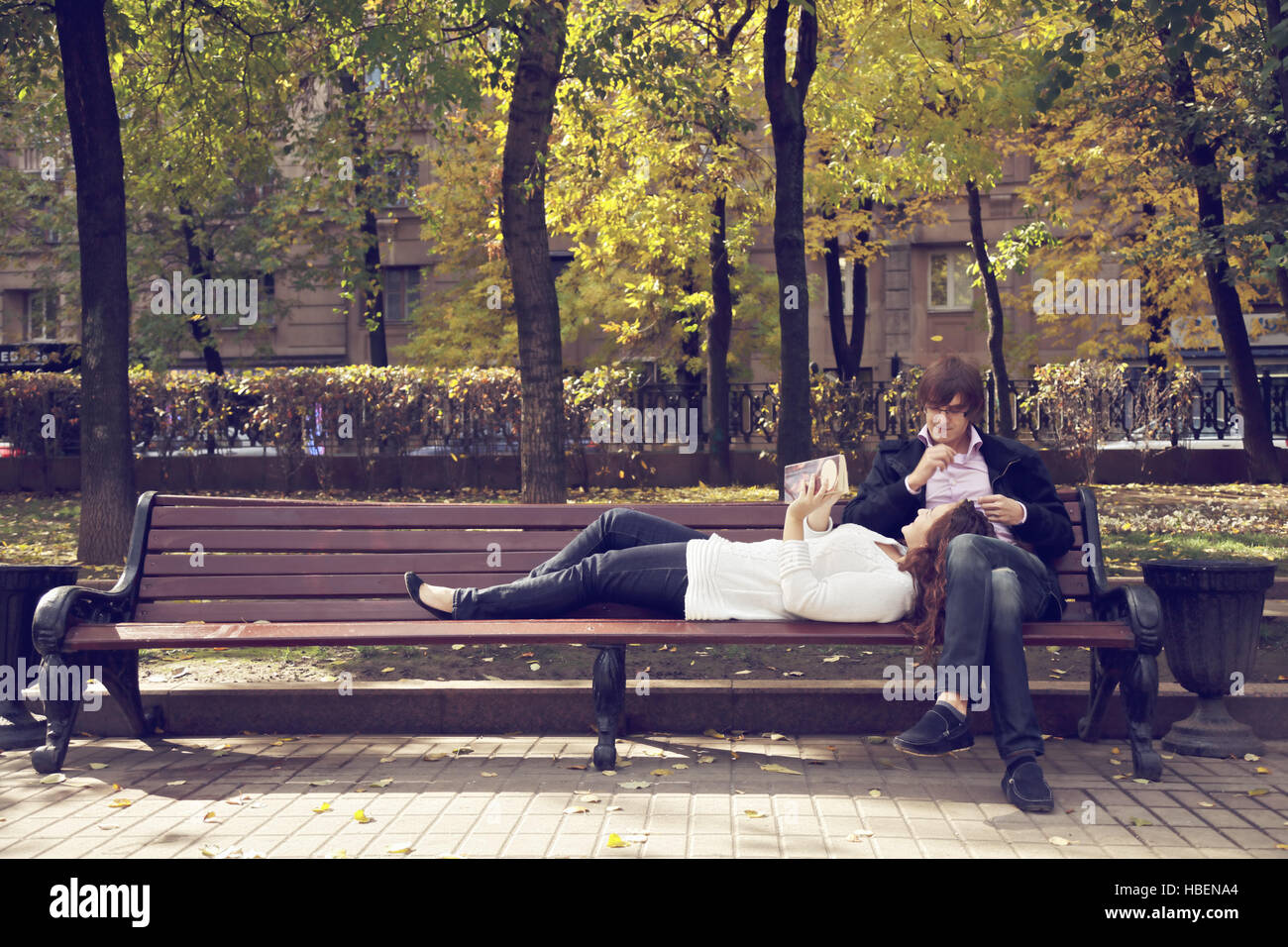 Couple on bench with book Stock Photo