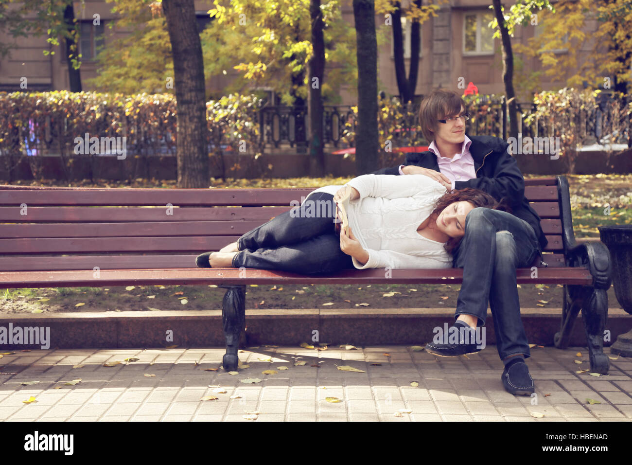 Couple on bench reading book Stock Photo