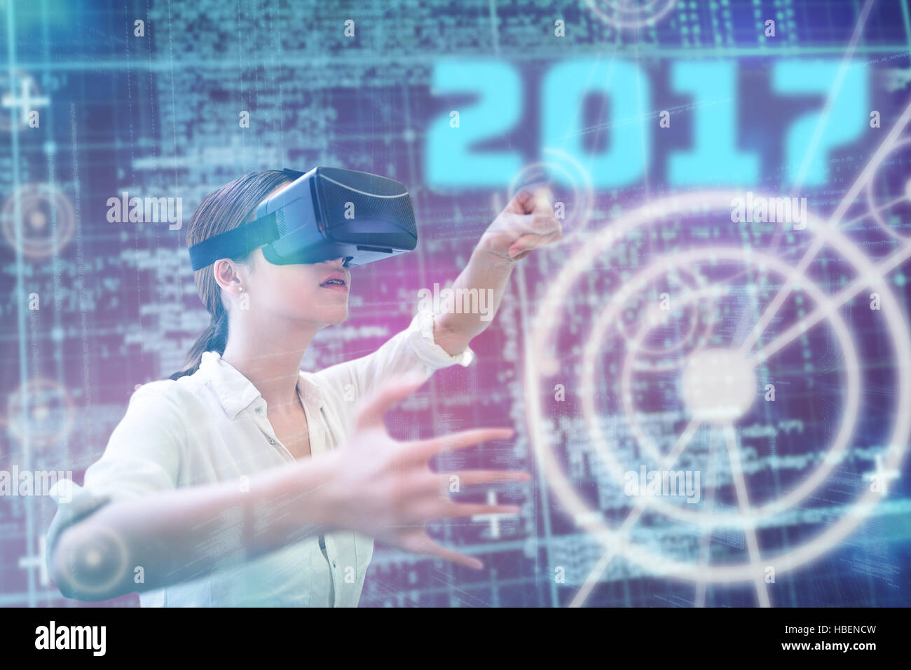 Composite image of woman using a virtual reality device Stock Photo